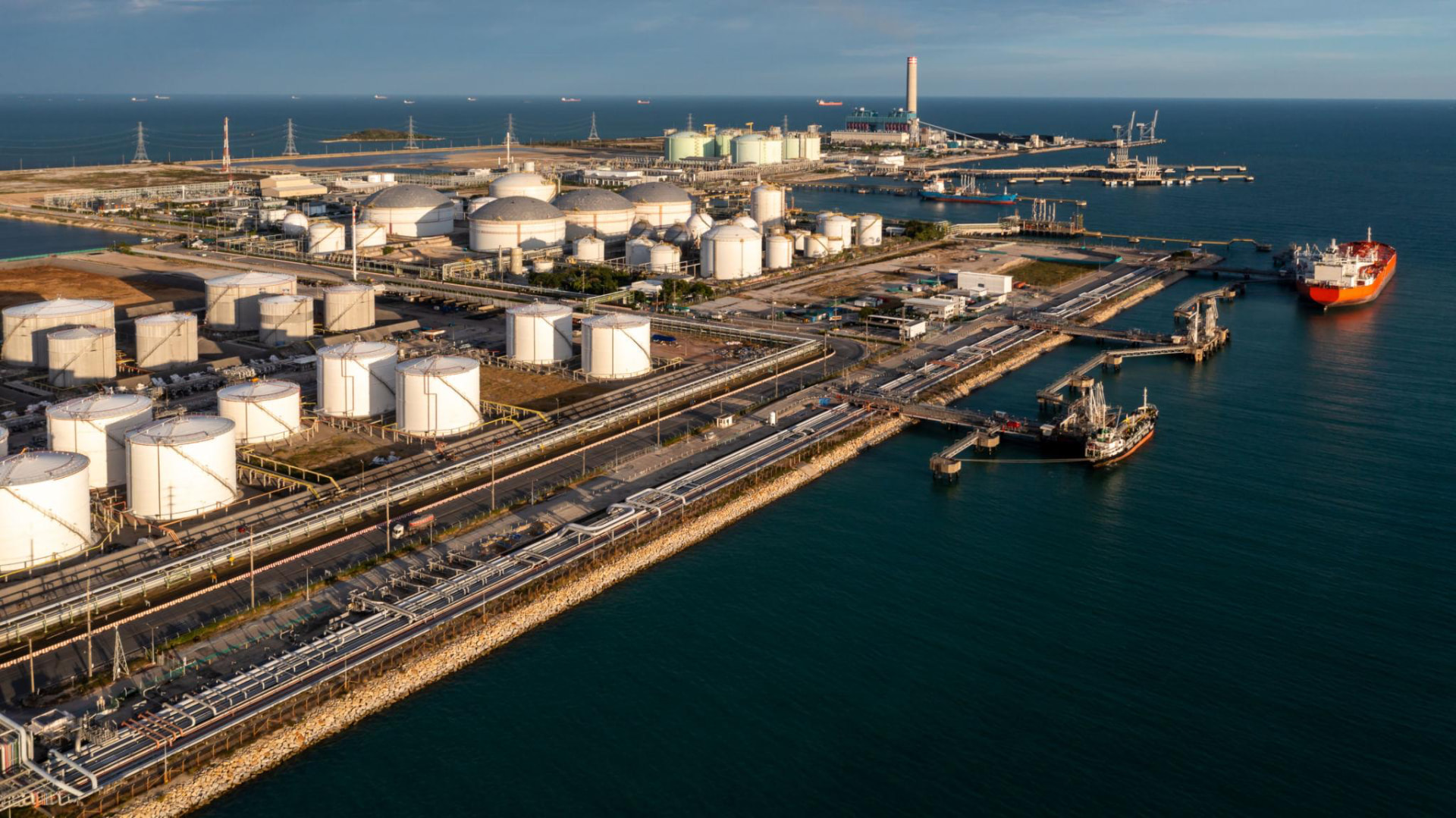 Aerial view of a coastal crude oil tank farm and marine jetty